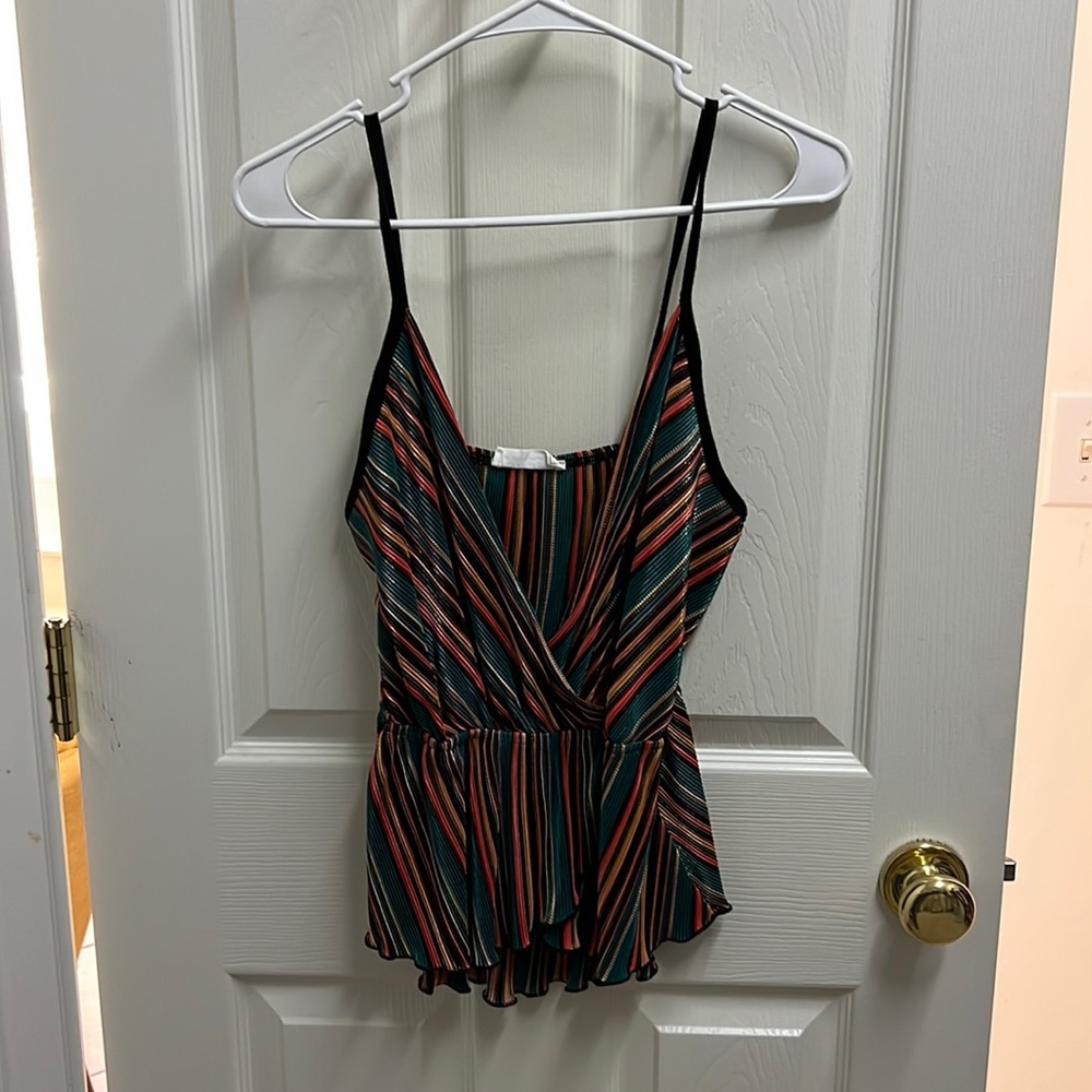 Cute boutique tank. Multi colored with gold shimmer. Black straps. Low cut.